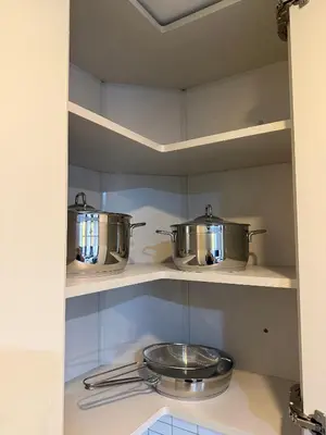 two pots and pans on shelves in a kitchen at Trio Houses in Istanbul