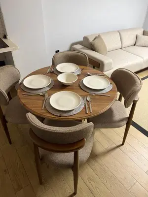 a wooden table with plates and chairs in a living room at Trio Houses in Istanbul