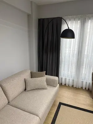 a living room with a couch and a large window at Trio Houses in Istanbul