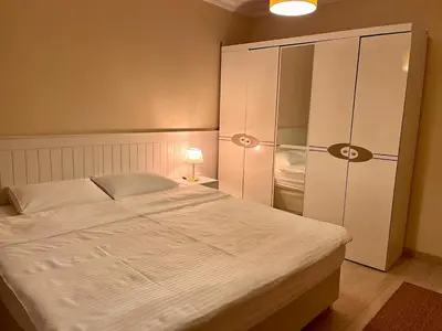 a bedroom with a large bed and a closet at Next to Cevahir Shopping Mall Perfect location comfortable luxury apartment in Istanbul