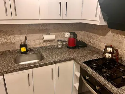 a kitchen counter with a sink and a stove at Next to Cevahir Shopping Mall Perfect location comfortable luxury apartment in Istanbul
