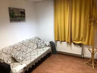 a living room with a couch and yellow curtains at Bahar 5 in Istanbul