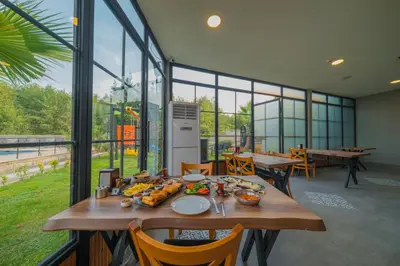 a table with food on it in a room with windows at Country Life Sapanca in Sapanca