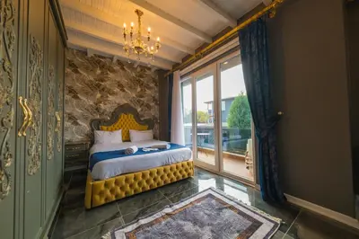 a bedroom with a bed and a large window at Country Life Sapanca in Sapanca