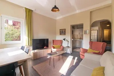 a living room with a couch and a tv at Calm & Charming 1BR with Shared Lush Garden Access in Istanbul