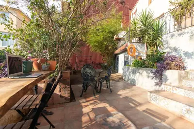 a patio with a table and chairs and plants at Calm & Charming 1BR with Shared Lush Garden Access in Istanbul