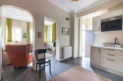 a kitchen with a table and a chair in a room at Calm & Charming 1BR with Shared Lush Garden Access in Istanbul