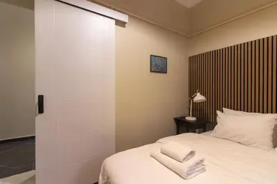 a bedroom with a white bed with two towels on it at Calm & Charming 1BR with Shared Lush Garden Access in Istanbul