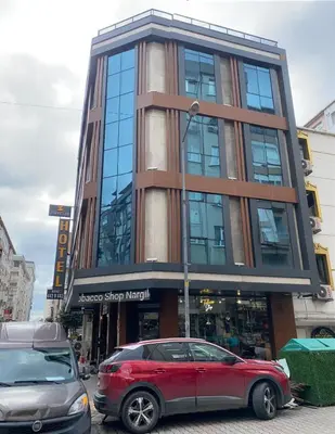 a red car parked in front of a building at Zirvesta Otel in Istanbul