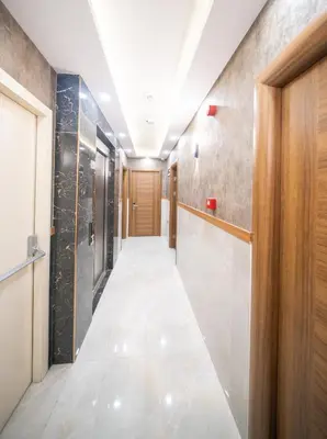 a corridor of a hallway with a door and a tile floor at Zirvesta Otel in Istanbul