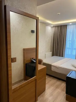 a hotel room with a bed and a mirror at Zirvesta Otel in Istanbul