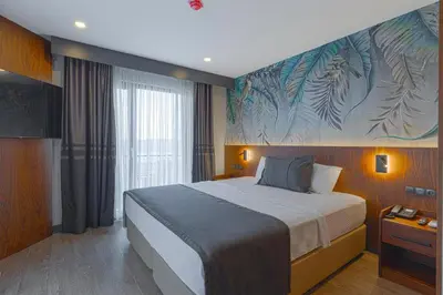 a bedroom with a bed with a large painting on the wall at Best Western Plus Sapanca in Sapanca