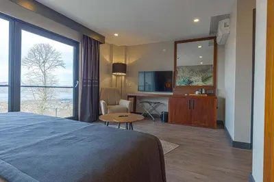 a hotel room with a bed and a large window at Best Western Plus Sapanca in Sapanca