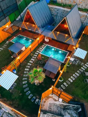 an overhead view of two swimming pools at night at Bungorise Bungalov in Sapanca