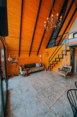 a living room with a couch and a staircase at Bungorise Bungalov in Sapanca