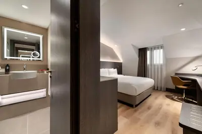 a hotel room with a bed and a sink at Ramada by Wyndham Arnavutkoy in Istanbul