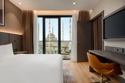 a hotel room with a bed and a large window at Ramada by Wyndham Arnavutkoy in Istanbul