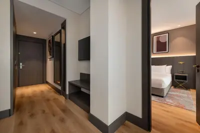 a hotel room with a bed and a mirror at Ramada by Wyndham Arnavutkoy in Istanbul