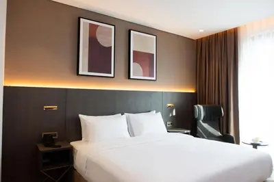a hotel room with a large bed and a window at Ramada by Wyndham Arnavutkoy in Istanbul