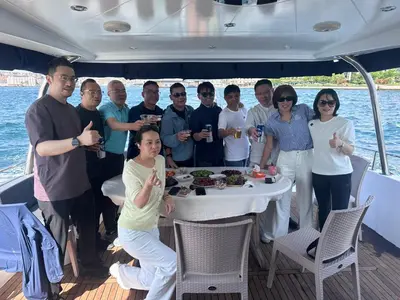 a group of people standing around a table on a boat at Private Luxury Bosphorus Yacht 2 Continents Experience in Istanbul