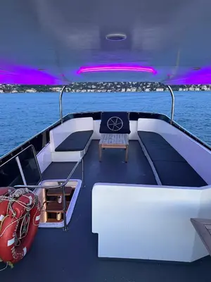 a boat sitting on the water with a red boat at Private Luxury Bosphorus Yacht 2 Continents Experience in Istanbul