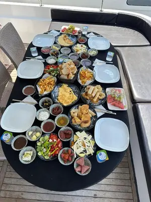 a table with a bunch of food on it at Private Luxury Bosphorus Yacht 2 Continents Experience in Istanbul