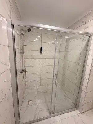 a shower with a glass door in a bathroom at Mütena konaklama in Mudanya
