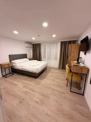 a bedroom with a bed and a desk and a desk at Mütena konaklama in Mudanya