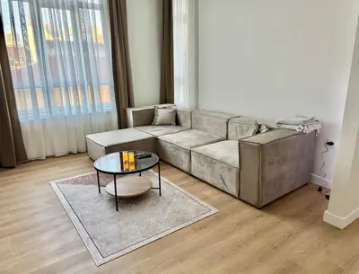 a living room with a couch and a table at Nisantasi - Spacious and Modern Loft House in Istanbul
