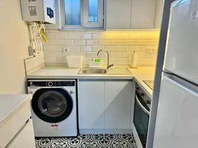 a kitchen with a washing machine and a sink at Nisantasi - Spacious and Modern Loft House in Istanbul