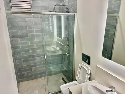 a bathroom with a shower and a toilet and a sink at Nisantasi - Spacious and Modern Loft House in Istanbul