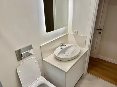 a white bathroom with a sink and a toilet at Nisantasi - Spacious and Modern Loft House in Istanbul