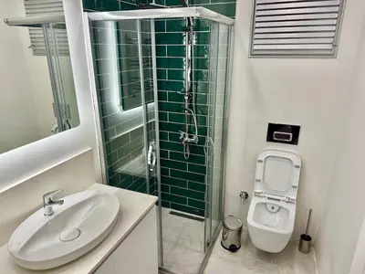 a bathroom with a sink and a shower and a toilet at Nisantasi - Spacious and Modern Loft House in Istanbul