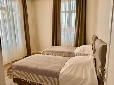 a bedroom with two beds and a window at Nisantasi - Spacious and Modern Loft House in Istanbul