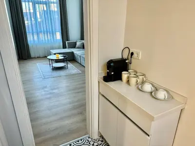a room with a table and a living room with a couch at Nisantasi - Spacious and Modern Loft House in Istanbul