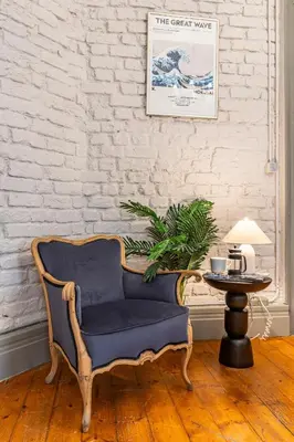 a chair in a living room with a table at Ganbaru Tours - Flats in Galata 2 in Istanbul