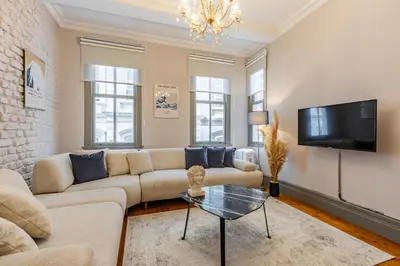 a living room with a couch and a tv at Ganbaru Tours - Flats in Galata 2 in Istanbul