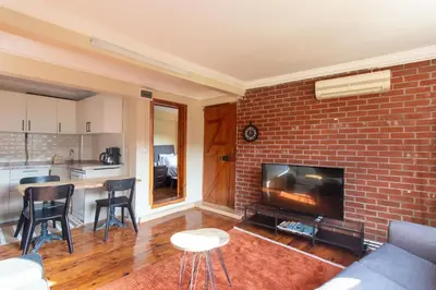 a living room with a brick wall at Leafy Views & Light Filled Comfort in Kuzguncuk in Istanbul