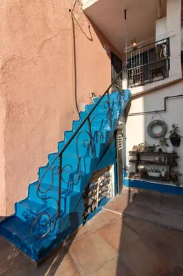 a blue staircase in a house with a wall at Leafy Views & Light Filled Comfort in Kuzguncuk in Istanbul