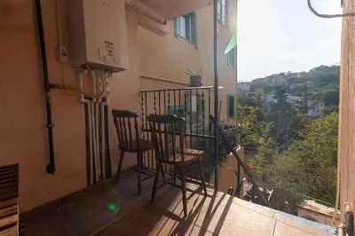 a balcony with two chairs and a window at Leafy Views & Light Filled Comfort in Kuzguncuk in Istanbul