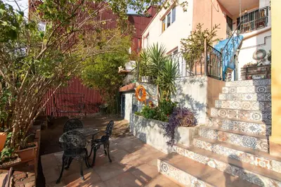 a patio with a table and chairs and a building at Leafy Views & Light Filled Comfort in Kuzguncuk in Istanbul