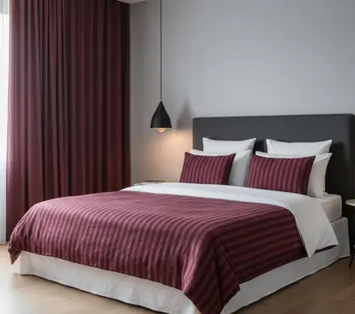 a bedroom with a large bed with red curtains at Yeni Yıl Apart in Bandırma