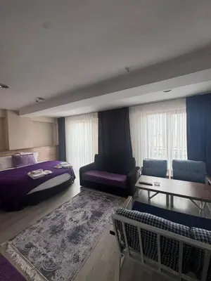a bedroom with a bed and a couch and a table at grand life hotel in Corlu