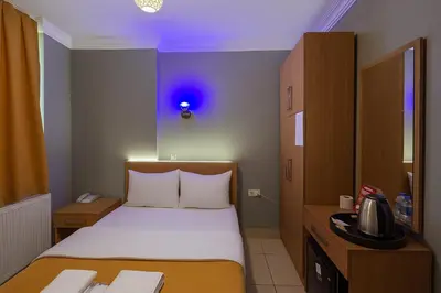 a small room with a bed and a blue light at ESEN Life HOTEL in Istanbul