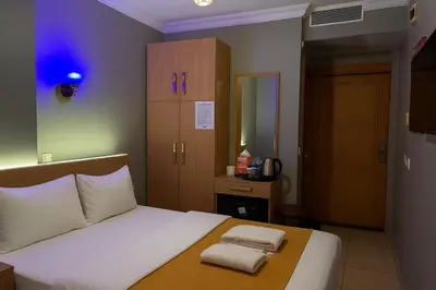 a bedroom with a bed with two towels on it at ESEN Life HOTEL in Istanbul