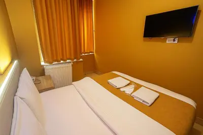 a bedroom with a bed with two towels on it at ESEN Life HOTEL in Istanbul