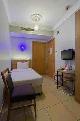 a bedroom with a bed and a desk and a tv at ESEN Life HOTEL in Istanbul