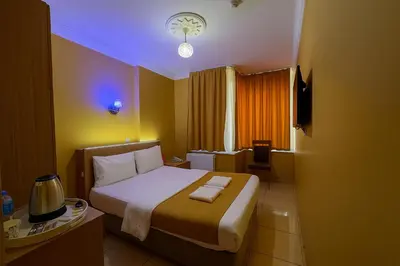 a hotel room with a bed with two towels on it at ESEN Life HOTEL in Istanbul