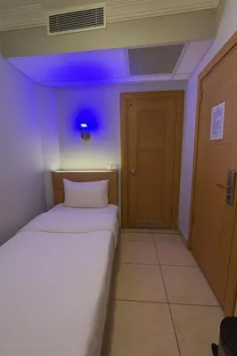 a bedroom with a bed with a blue light on the ceiling at ESEN Life HOTEL in Istanbul