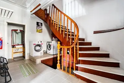 a wooden staircase in a room with a washing machine at Timeless House Overlooking the Golden Horn with Sea - Nilorayn in Istanbul